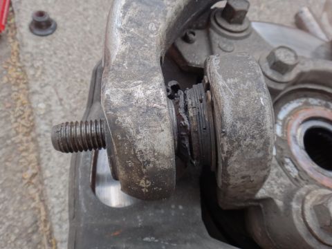 2000 Lincoln Continental - This suspension component shows significant wear and damage to its bushing.