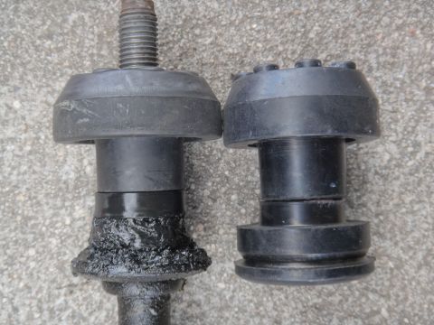 2000 Lincoln Continental - Comparison of a worn, greased suspension part next to a new one.