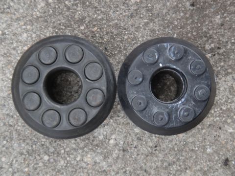 2000 Lincoln Continental - Two suspension components are shown side-by-side on a concrete background.
