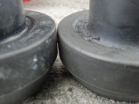 2000 Lincoln Continental - Two rubber suspension components are shown in close proximity, with one exhibiting signs of wear and accumulated debris.