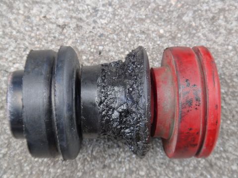 2000 Lincoln Continental - Close-up of a severely worn suspension bushing, showing torn rubber and expelled grease.