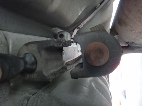 2000 Lincoln Continental - Close-up of a damaged suspension bushing, showing the part number 'AHA' stamped on the metal casing.