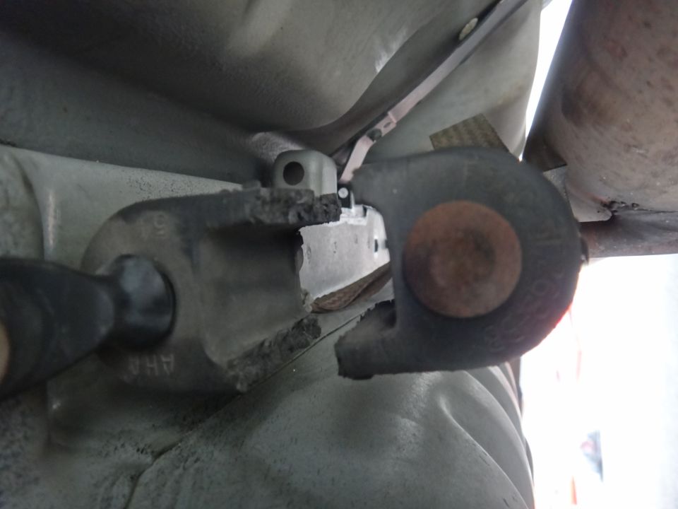 Damaged suspension bushing with visible part number 'AHA'