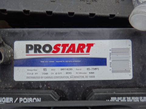 2000 Lincoln Continental - A car battery's label displays specifications and manufacturer information.
