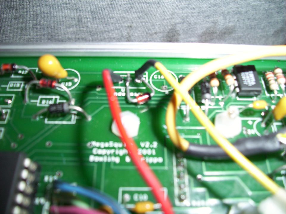 Circuit board with "MegaSquirt V2.2 Copyright 2001" text and red, yellow, and blue wires