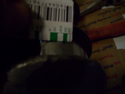 1995 Ford Probe - A barcode label is placed over dark packaging, with text visible on the packaging.