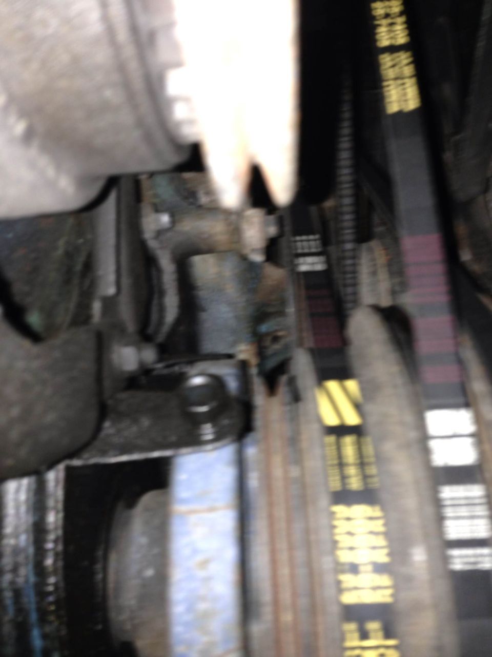 Engine belts with yellow and purple stripes, some text visible