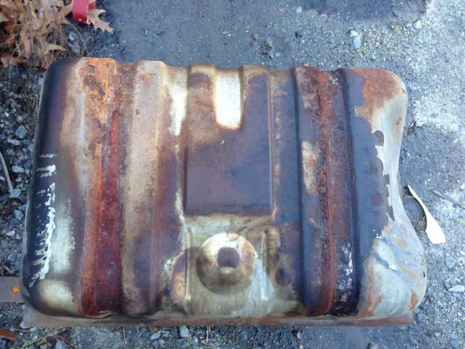 rusted fuel tank sitting on the ground