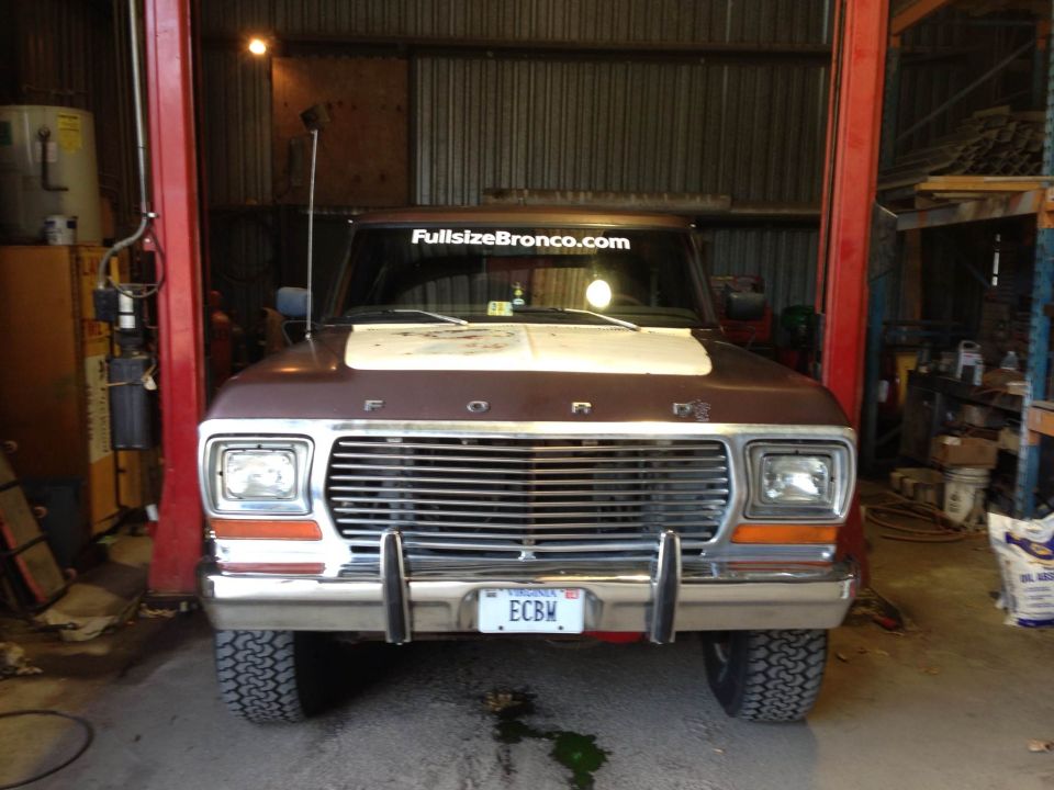 Front view of a brown 1979 Ford Bronco with a white hood