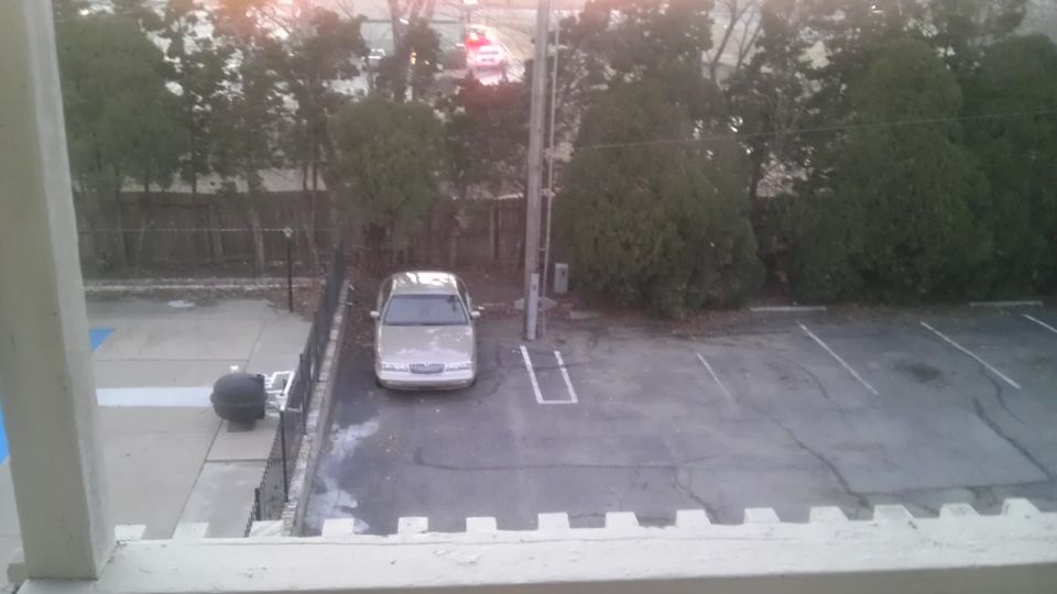 Silver sedan parked in a lot, front view. The car appears to be a 2000 Mercury Grand Marquis