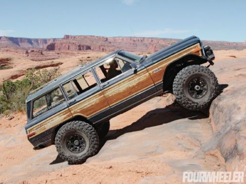 1982 Jeep Wagoneer - This 1982 Jeep Grand Wagoneer is tackling a steep, rocky trail in a desert landscape.