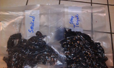 1989 Ford Bronco - Homemade jerky, labeled 'Smoked' and 'Spicy Teriyaki', is sealed in plastic bags.