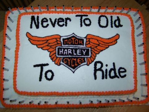 1989 Ford Bronco - A cake decorated with the Harley-Davidson logo and the phrase 'Never To Old To Ride', surrounded by candles.