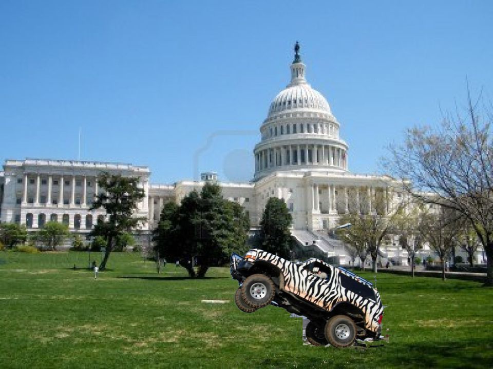 Off-road vehicle with zebra stripes doing a jump in front of the Capitol building