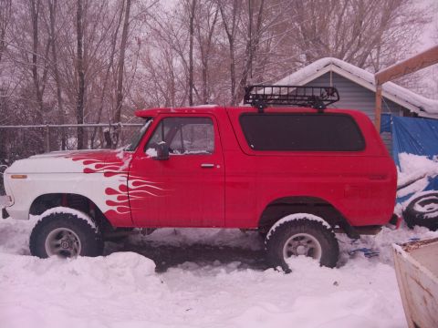 1979 Ford Bronco - This 1979 Ford Bronco, flame decals and a roof rack, is parked in the snow.