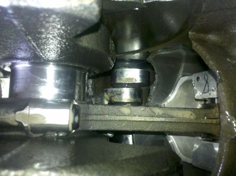 1996 Ford Bronco - This image shows internal engine components, specifically the crankshaft and connecting rod, with signs of wear.