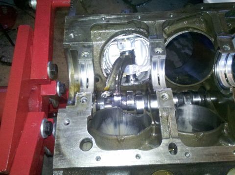 1996 Ford Bronco - Engine block with a broken connecting rod and damaged piston, supported by a red stand.