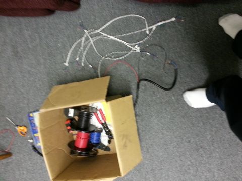1978 Ford Bronco - A collection of electrical wiring components, including spools of wire and loose cables, are spread out on a carpeted surface.
