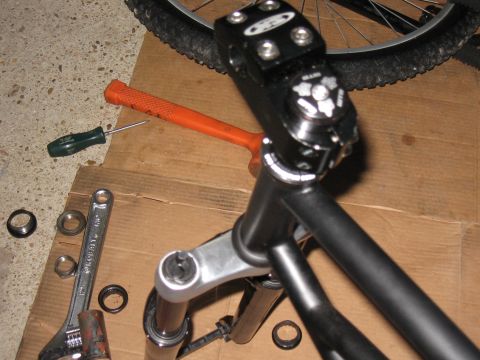 1994 Ford Bronco - Tools and bicycle parts are laid out on cardboard for assembly.