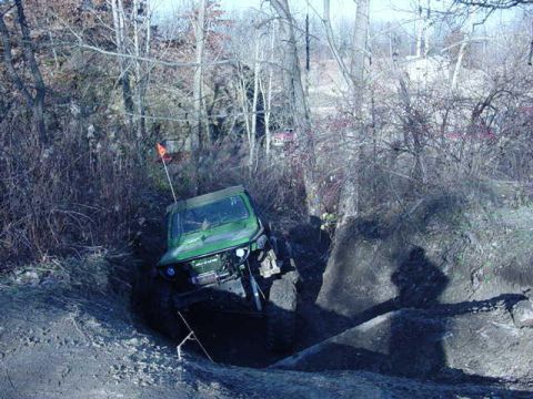 1992 Ford Bronco - Off-road vehicle navigates a challenging ditch during an event.