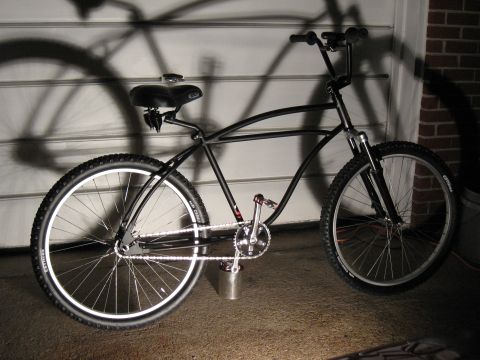 1994 Ford Bronco - Custom cruiser bicycle with wide tires, parked in front of a garage door.