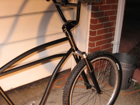 1994 Ford Bronco - Close-up view of a bicycle's front end, including the handlebars and wheel, with a bucket nearby.