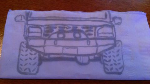 1995 Ford Bronco - This drawing depicts the front view of an off-road SUV with prominent tires, rendered on a napkin.