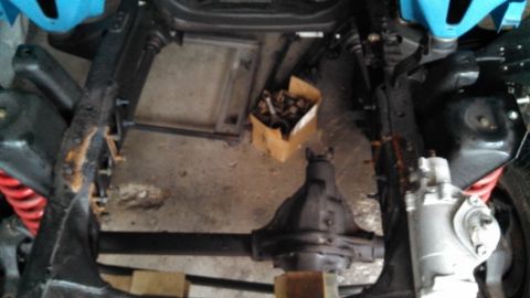 1977 Ford F-150 - The underside of a vehicle is shown, focusing on the frame, suspension, and rear axle assembly.