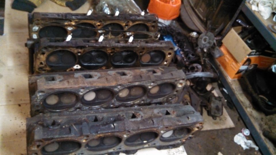 Stack of four used engine cylinder heads