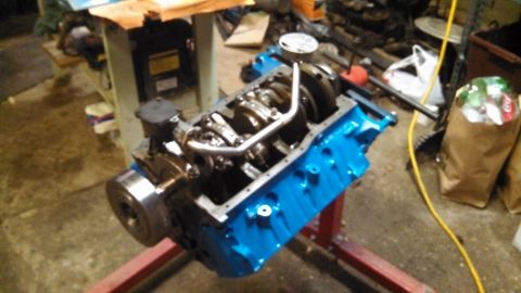 1977 Ford F-150 - Engine block assembly with internal components visible, resting on a stand in a workshop.