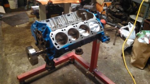 1977 Ford F-150 - Engine block on a stand in a workshop setting.