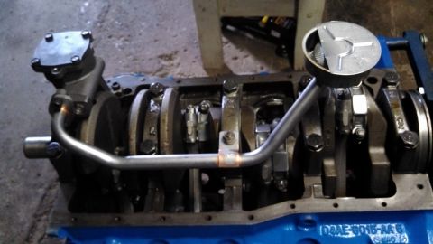 1977 Ford F-150 - Close-up of an engine block assembly, showing internal components like the crankshaft and oil pump.