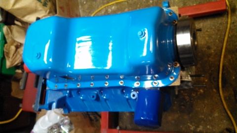 1977 Ford F-150 - A freshly painted blue engine oil pan is shown with a blue oil filter installed.