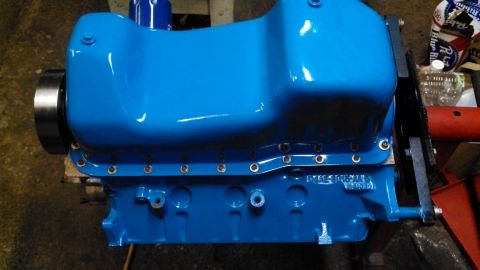 1977 Ford F-150 - A blue painted engine block is shown with a metal pulley attached to the crankshaft end.