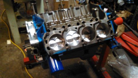 1977 Ford F-150 - Close-up of a V8 engine block, revealing the pistons and cylinder walls, mounted on an engine stand.