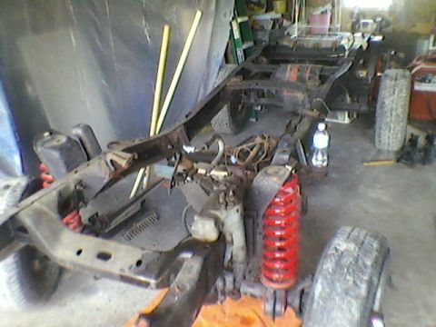1977 Ford F-150 - The frame of a truck is visible, undergoing restoration in a garage setting.
