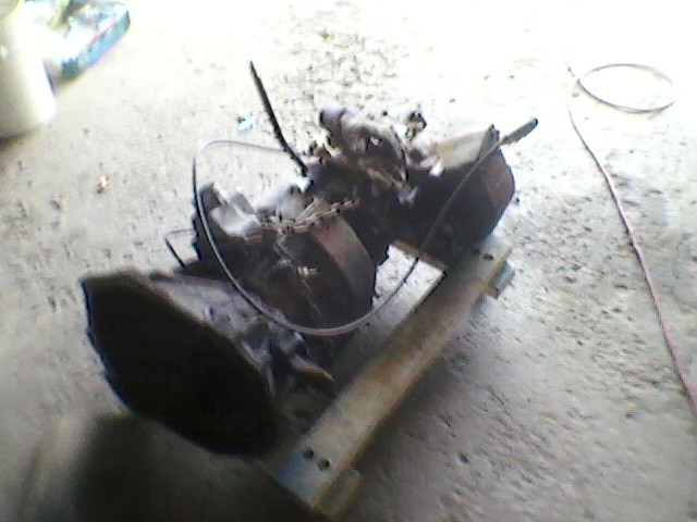 Transmission and engine components on a wooden stand
