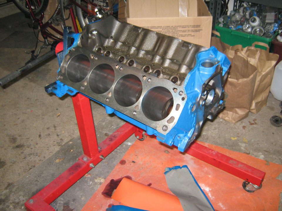 Blue engine block on red stand
