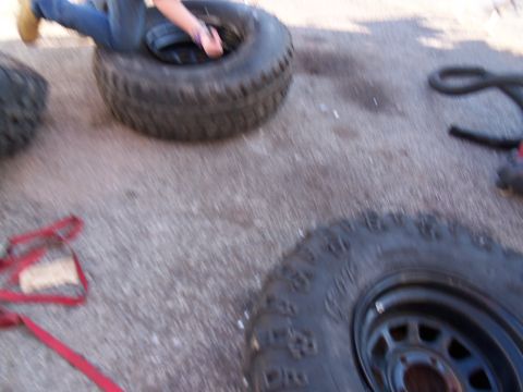 1987 Ford Ranger - Tires and a red strap are visible on a paved surface.