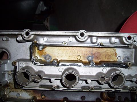1995 Ford Probe - This is a close-up view of a vehicle's engine valve cover, showing signs of oil leakage.