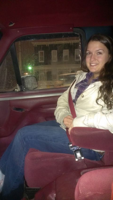 1995 Ford Bronco - Interior view of a woman seated in a vehicle with maroon upholstery and a visible seatbelt.