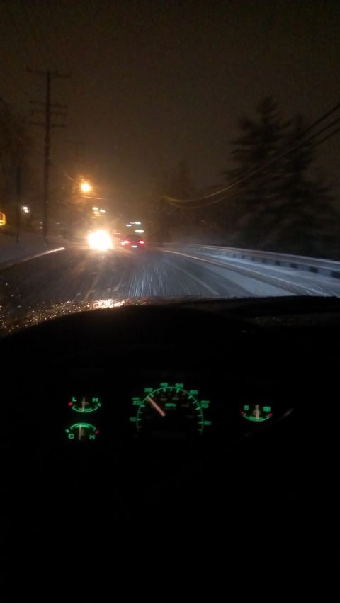 1995 Ford Bronco - Driving through snow at night, with a view of the dashboard gauges and the road ahead.