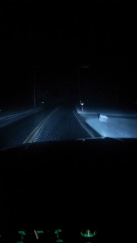 1995 Ford Bronco - Driving at night, the headlights cut through the darkness, illuminating the road ahead.