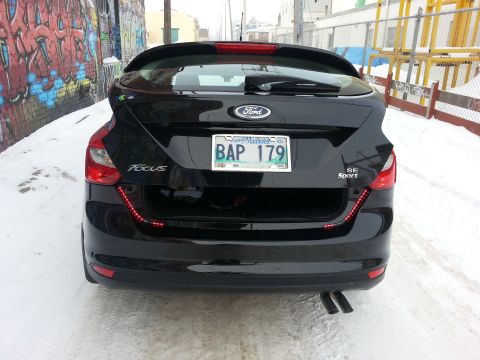 2012 Ford Focus - Black 2012 Ford Focus SE Sport hatchback parked in snow with graffiti wall.