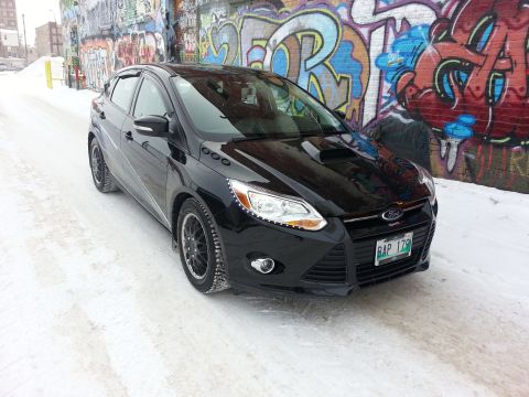 2012 Ford Focus - 2012 Ford Focus ST hatchback in the snow, parked by a graffiti-covered wall.