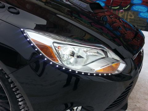 2012 Ford Focus - Front view of a black car with custom LED lighting on the headlight assembly.
