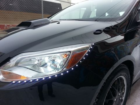 2012 Ford Focus - A black 2012 Ford Focus is shown with a hood scoop and custom LED accent lighting along the fender.