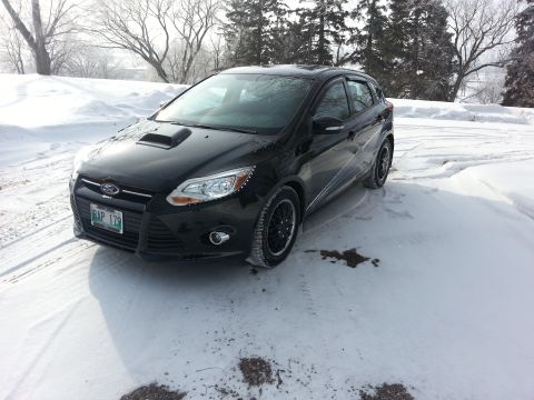 2012 Ford Focus - Black 2012 Ford Focus with aftermarket hood scoop sits in a snowy landscape.