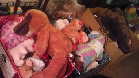 1982 Jeep Wagoneer - A collection of stuffed animals is stored in boxes, with a large dog toy in the foreground.