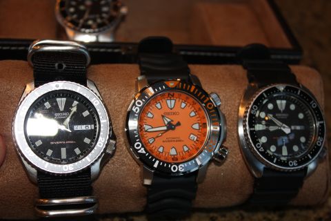 1986 Ford Bronco - Three Seiko automatic dive watches are shown, each with a different dial color and strap configuration.